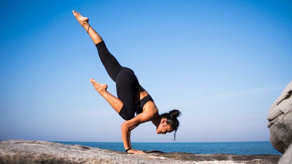 happiness and health - woman doing yoga on a rock.jpg