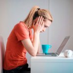CBT therapy for hypochondria - woman at laptop
