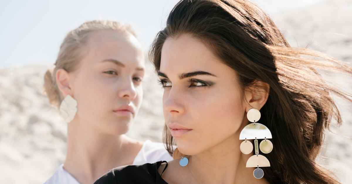 status envy - two girls with earrings
