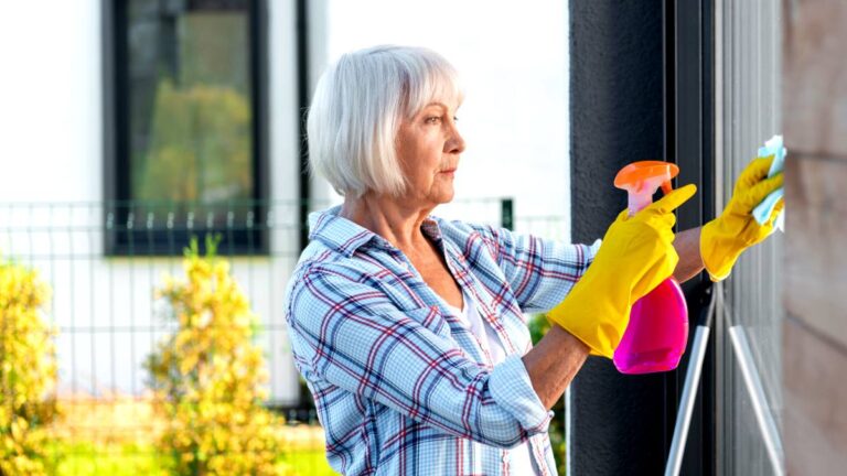 housework helps sharpen cognitive skills of elderly - older woman washing window